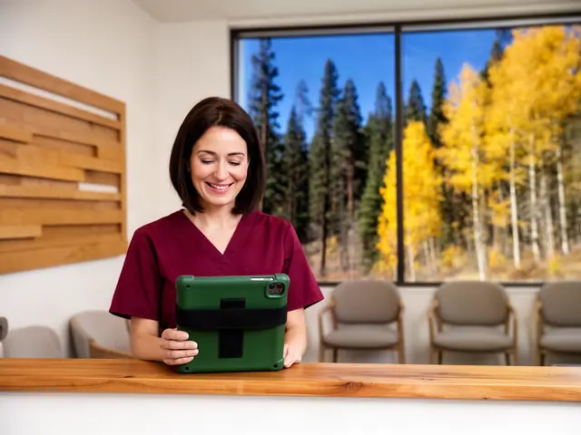 Office manager of a dental practice holding a tablet at the front desk